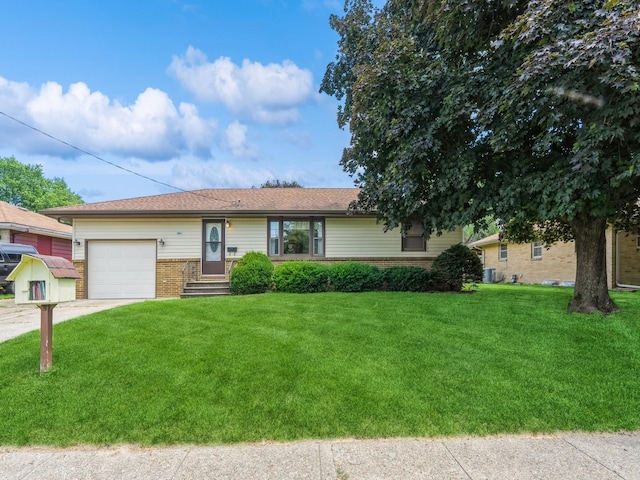 4041 Columbia St, Des Moines, IA 50313 - ranch-style home featuring brick siding, an attached garage, a front lawn, and concrete driveway