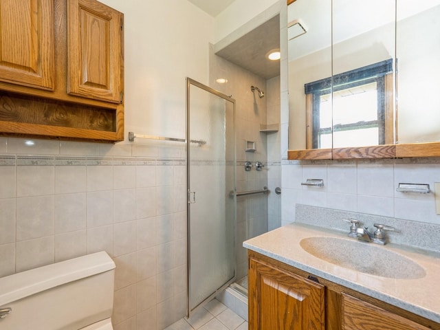4041 Columbia St, Des Moines, IA 50313 - full bath featuring tile walls, a stall shower, vanity, and tile patterned floors
