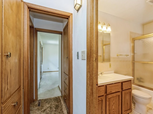 4041 Columbia St, Des Moines, IA 50313 - full bathroom featuring vanity and shower / bath combination with glass door