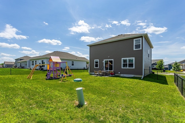 1413 NE Park St, Grimes, IA 50111 - back of property with a playground, a fenced backyard, and a patio area