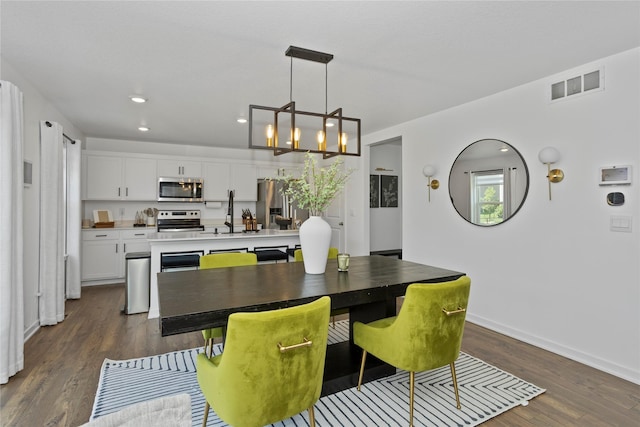 1413 NE Park St, Grimes, IA 50111 - dining space featuring dark wood-style flooring, a chandelier, and recessed lighting