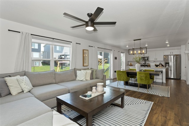 1413 NE Park St, Grimes, IA 50111 - living area featuring dark wood-style floors, ceiling fan, recessed lighting, and a chandelier