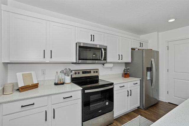 1413 NE Park St, Grimes, IA 50111 - kitchen featuring appliances with stainless steel finishes, white cabinets, dark wood-style floors, and recessed lighting