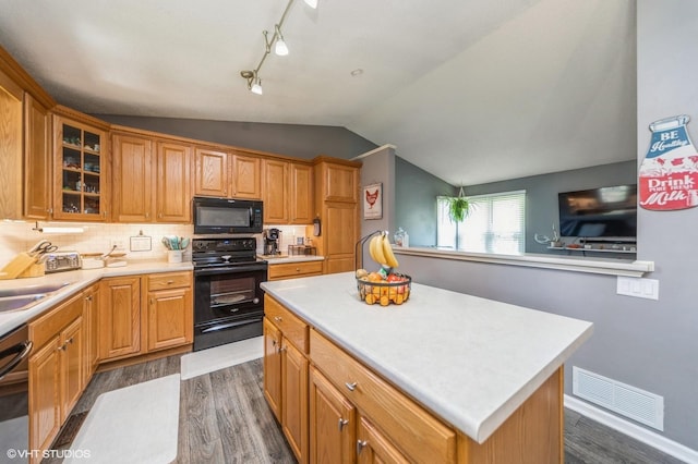 500 NW Valley View Dr, Grimes, IA 50111 - kitchen featuring black appliances, dark wood finished floors, lofted ceiling, light countertops, and glass insert cabinets