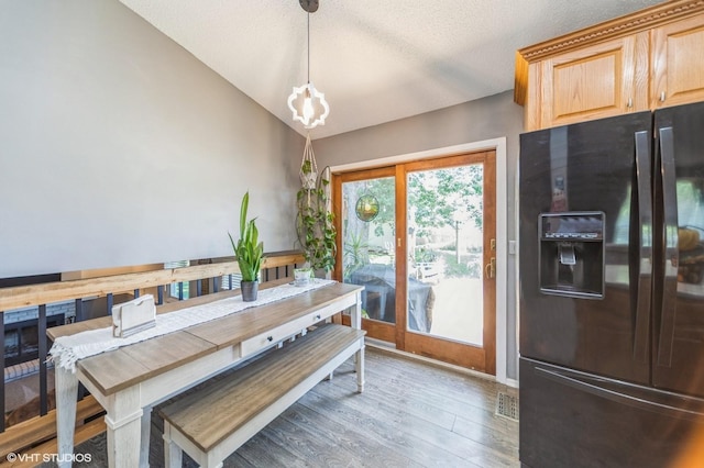 500 NW Valley View Dr, Grimes, IA 50111 - dining space featuring vaulted ceiling, light wood-style floors, and a chandelier