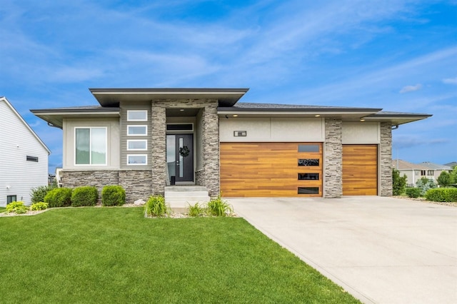 905 NE Badger Ln, Waukee, IA 50263 - prairie-style home featuring stone siding, an attached garage, a front yard, and driveway