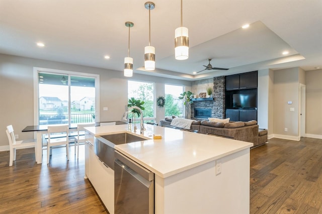 905 NE Badger Ln, Waukee, IA 50263 - kitchen featuring dishwasher, a raised ceiling, recessed lighting, a center island with sink, and dark wood-type flooring