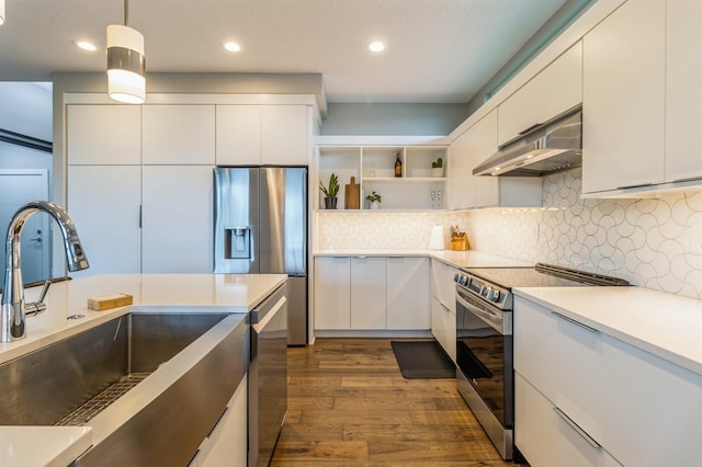 905 NE Badger Ln, Waukee, IA 50263 - kitchen featuring appliances with stainless steel finishes, range hood, modern cabinets, white cabinetry, and recessed lighting