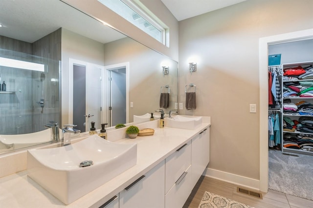 905 NE Badger Ln, Waukee, IA 50263 - full bath with double vanity, an enclosed shower, and a spacious closet
