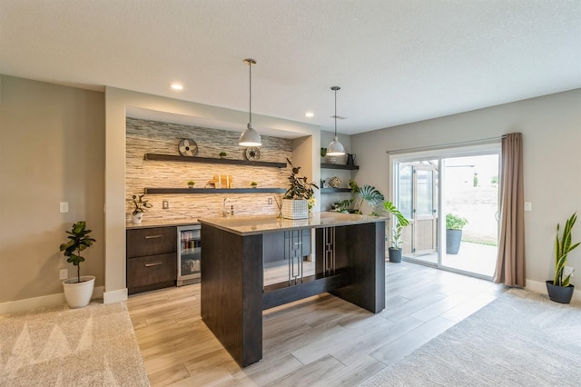 905 NE Badger Ln, Waukee, IA 50263 - bar area with beverage cooler, recessed lighting, hanging light fixtures, and light wood-style floors