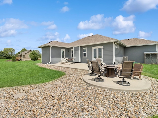 2458 SE 108th St, Runnells, IA 50237 - back of property featuring a patio area, a fire pit, a yard, and a shingled roof