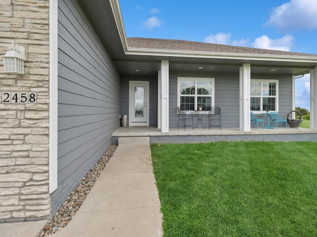 2458 SE 108th St, Runnells, IA 50237 - entrance to property with a porch, a lawn, and roof with shingles