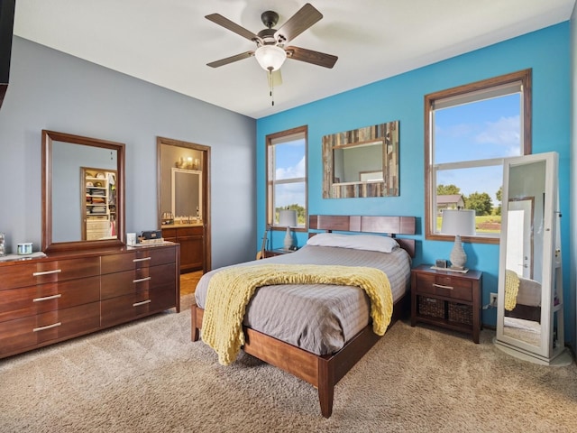 2458 SE 108th St, Runnells, IA 50237 - bedroom with carpet floors, a ceiling fan, and ensuite bath