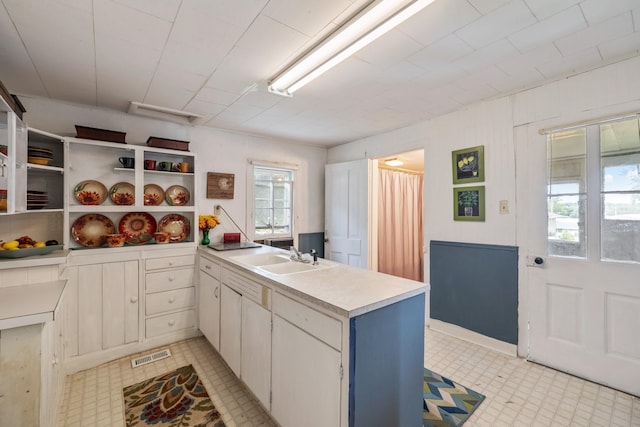 311 E 4th St, Riverside, IA 52327 - kitchen featuring a peninsula, light countertops, and light flooring