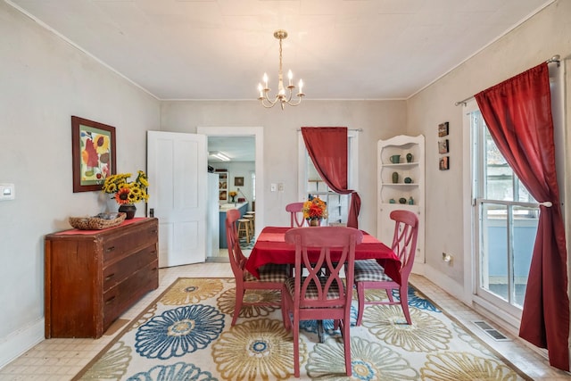 311 E 4th St, Riverside, IA 52327 - dining space featuring a chandelier and crown molding