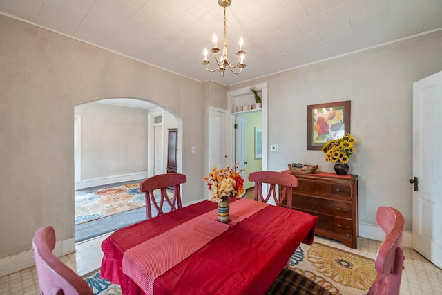 311 E 4th St, Riverside, IA 52327 - dining room featuring arched walkways, a chandelier, ornamental molding, and tile patterned floors