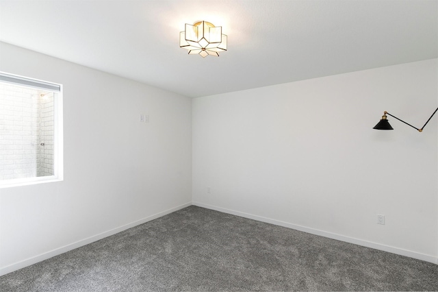 427 Spring Crest Ln, Waukee, IA 50263 - spare room with dark colored carpet and baseboards
