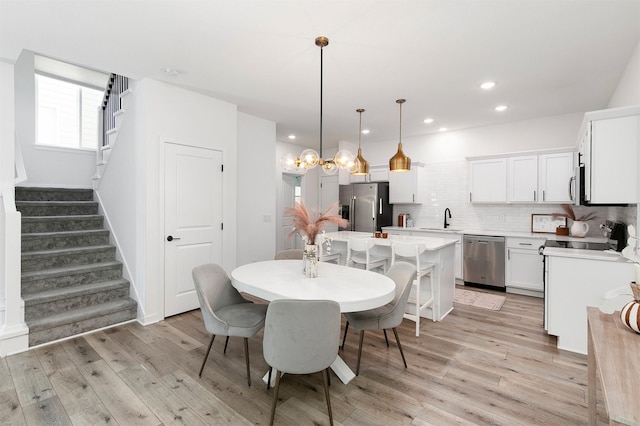 427 Spring Crest Ln, Waukee, IA 50263 - dining room featuring stairs, light wood finished floors, and recessed lighting