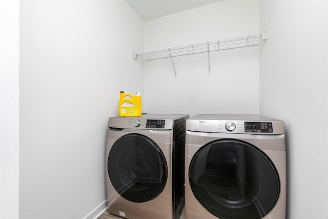 427 Spring Crest Ln, Waukee, IA 50263 - washroom featuring washer and clothes dryer and baseboards