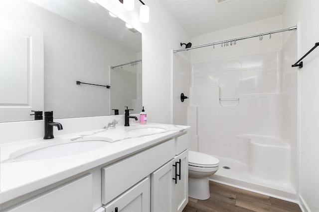 427 Spring Crest Ln, Waukee, IA 50263 - bathroom with wood finished floors, double vanity, and a shower