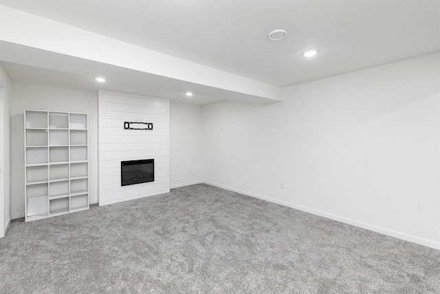 427 Spring Crest Ln, Waukee, IA 50263 - unfurnished living room with carpet flooring, a large fireplace, and recessed lighting