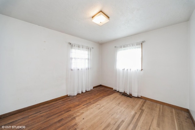 7012 Sunrise Blvd, Windsor Heights, IA 50324 - empty room with baseboards and light wood-style flooring
