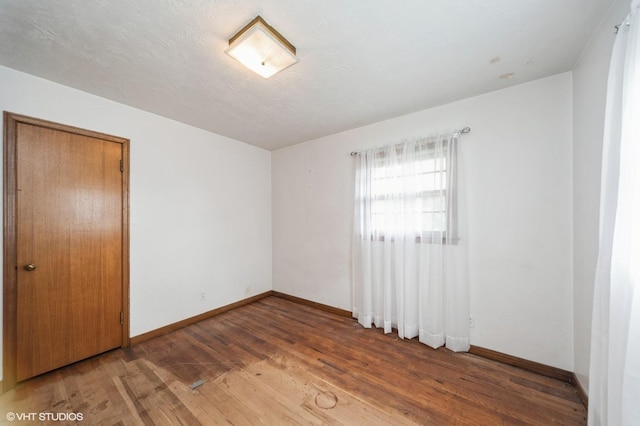 7012 Sunrise Blvd, Windsor Heights, IA 50324 - unfurnished bedroom with hardwood / wood-style flooring and a closet