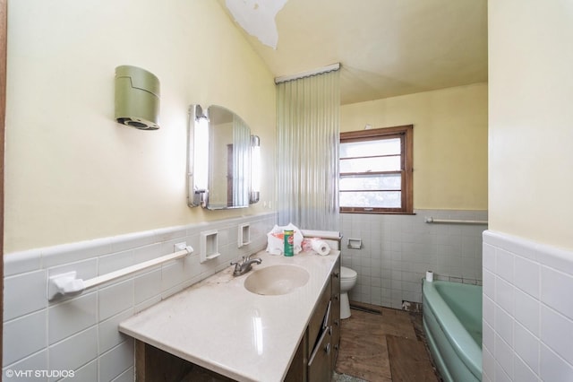 7012 Sunrise Blvd, Windsor Heights, IA 50324 - full bathroom with tile walls, vanity, a wainscoted wall, and a garden tub