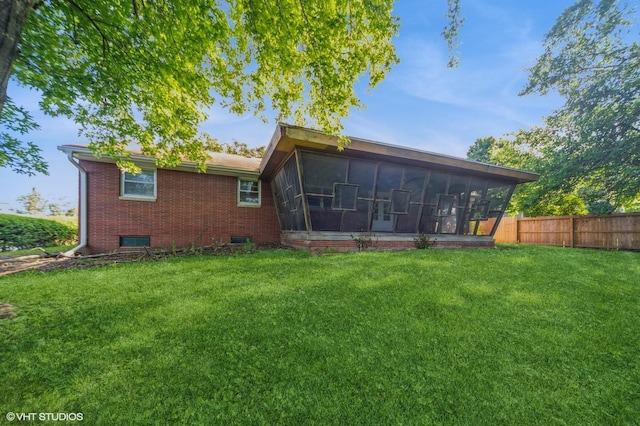 7012 Sunrise Blvd, Windsor Heights, IA 50324 - back of house featuring a sunroom and brick siding