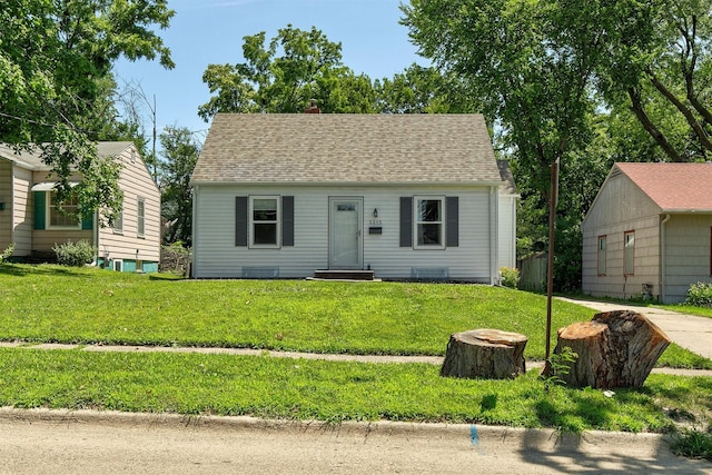 3315 61st St, Des Moines, IA 50322 - view of front of house with entry steps, a front lawn, a chimney, and roof with shingles