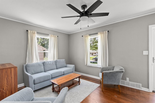 3315 61st St, Des Moines, IA 50322 - living area with plenty of natural light, wood finished floors, ceiling fan, and ornamental molding