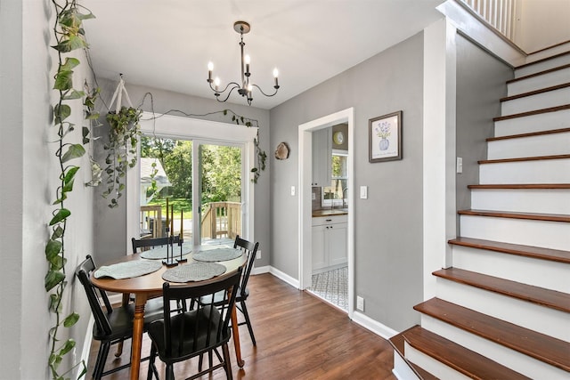 3315 61st St, Des Moines, IA 50322 - dining space featuring stairs, a chandelier, and dark wood finished floors
