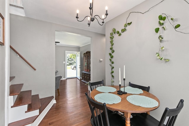 3315 61st St, Des Moines, IA 50322 - dining area featuring stairs, wood finished floors, and a chandelier