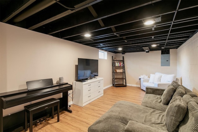 3315 61st St, Des Moines, IA 50322 - living room featuring electric panel, light wood finished floors, and concrete block wall