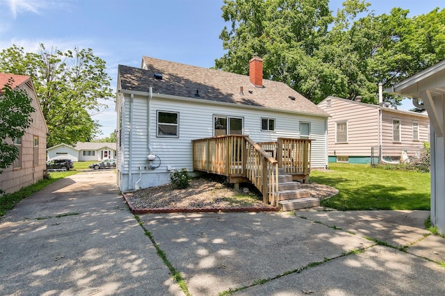 3315 61st St, Des Moines, IA 50322 - back of house with a chimney, a yard, a wooden deck, and a shingled roof