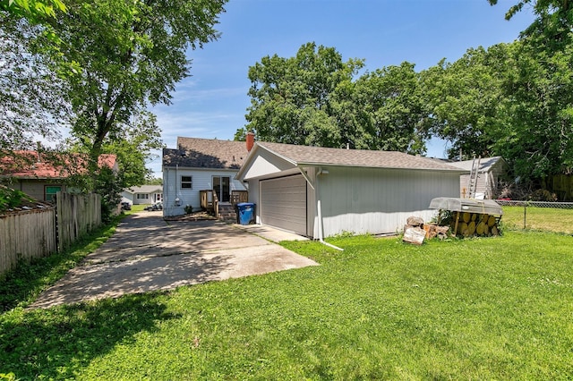 3315 61st St, Des Moines, IA 50322 - rear view of property featuring a garage and an outbuilding