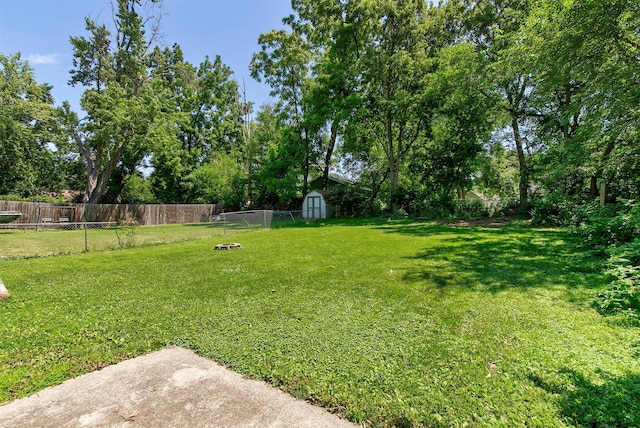 3315 61st St, Des Moines, IA 50322 - fenced backyard with a storage shed and view of wooded area