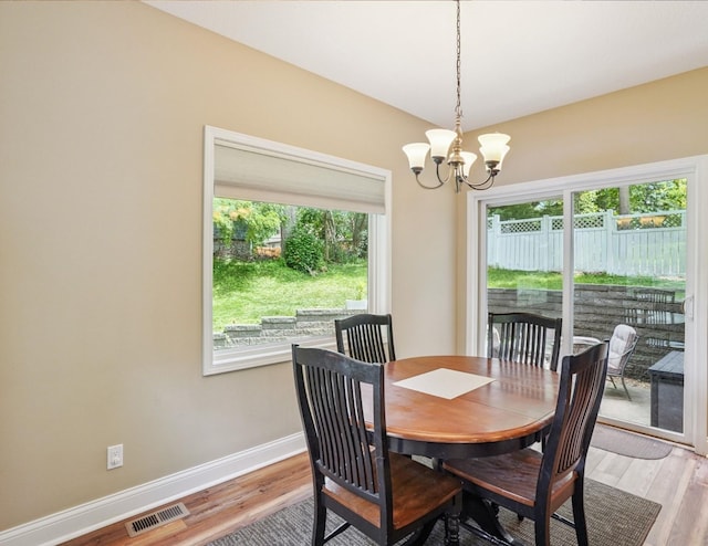 929 Sampson Dr, Nevada, IA 50201 - dining area with a chandelier and light wood-type flooring