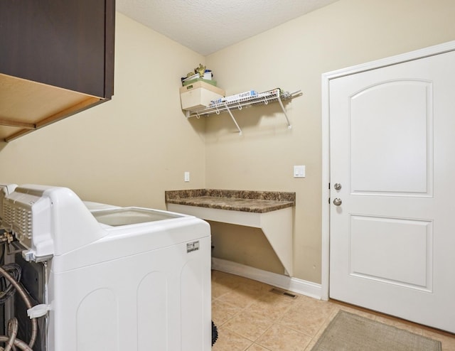 929 Sampson Dr, Nevada, IA 50201 - washroom with washer / dryer and light tile patterned flooring
