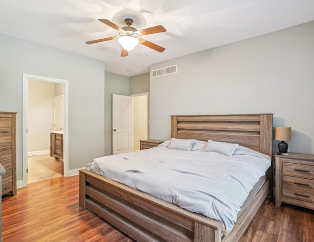 929 Sampson Dr, Nevada, IA 50201 - bedroom with wood finished floors, ceiling fan, and connected bathroom