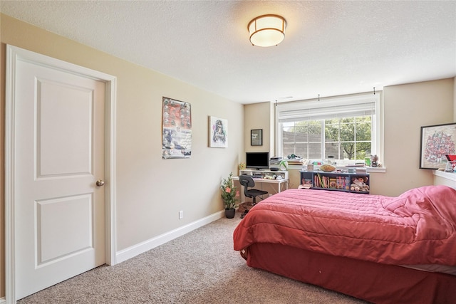 929 Sampson Dr, Nevada, IA 50201 - bedroom featuring carpet floors, a textured ceiling, and an office area