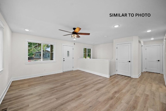 2517 Shaw St, Des Moines, IA 50317 - unfurnished living room featuring healthy amount of natural light, light wood-type flooring, a ceiling fan, and recessed lighting