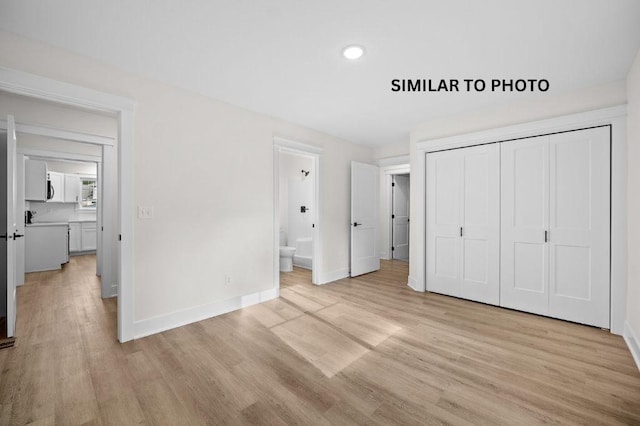 2517 Shaw St, Des Moines, IA 50317 - unfurnished bedroom featuring light wood finished floors, recessed lighting, a closet, and connected bathroom