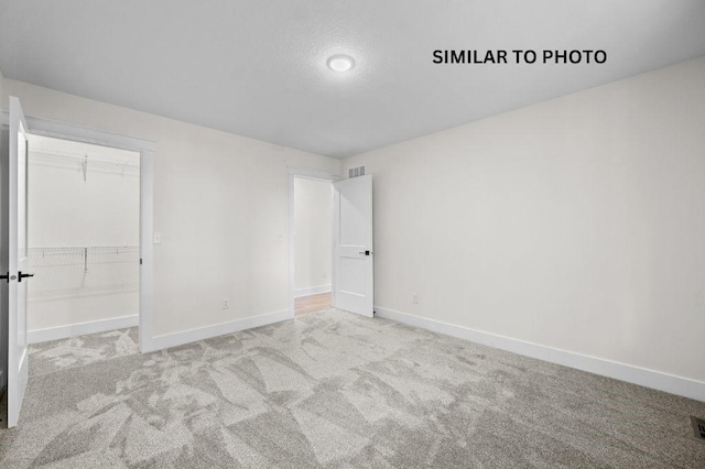 2517 Shaw St, Des Moines, IA 50317 - unfurnished bedroom featuring carpet flooring and a spacious closet