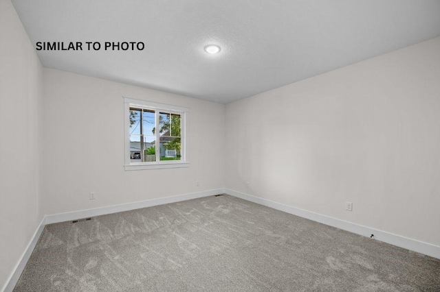2517 Shaw St, Des Moines, IA 50317 - unfurnished room with baseboards and carpet floors