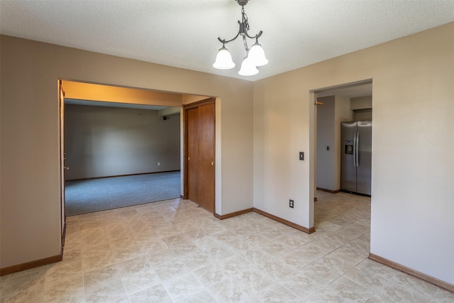 4624 Tamara Ln, West Des Moines, IA 50265 - unfurnished room with a chandelier and baseboards