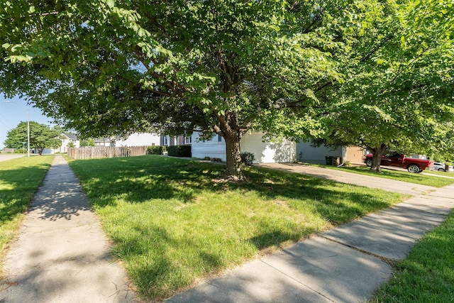 4624 Tamara Ln, West Des Moines, IA 50265 - view of property hidden behind natural elements featuring a garage and driveway