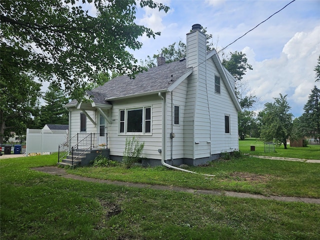 4690 Hubbell Ave, Des Moines, IA 50317 - view of home's exterior with a chimney and roof with shingles