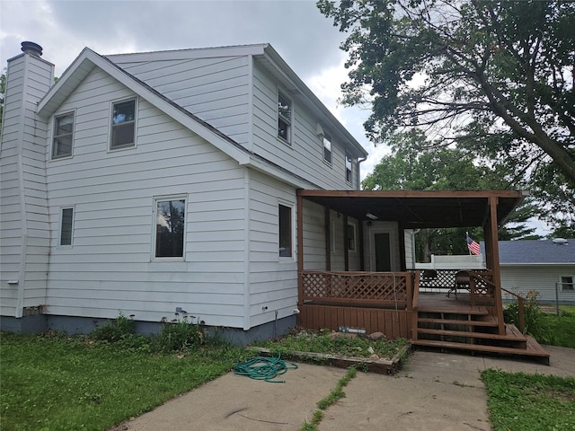 4690 Hubbell Ave, Des Moines, IA 50317 - back of house featuring a chimney and covered porch