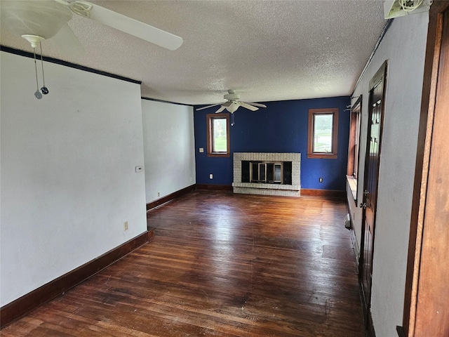 4690 Hubbell Ave, Des Moines, IA 50317 - unfurnished living room with ceiling fan, wood finished floors, a textured ceiling, and a brick fireplace
